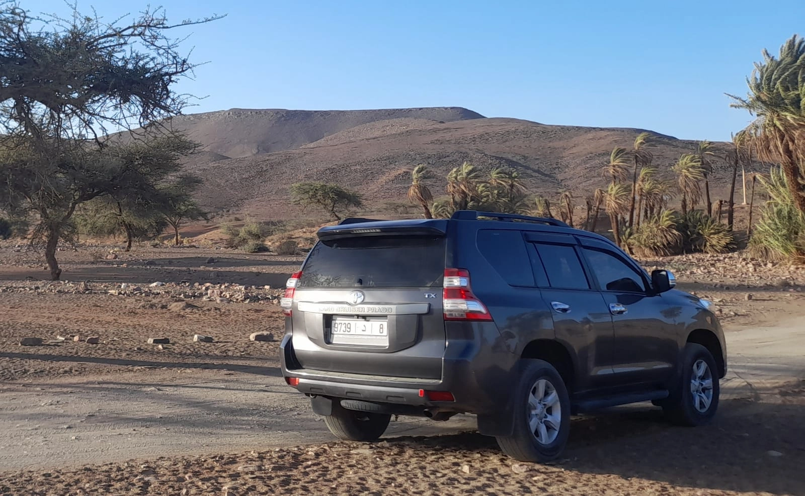 Luxury car at Sahara Desert sunset